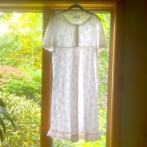 Demure nightgown eyelet bows and lace at neckline and front bodice.